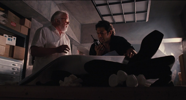 Wide shot frame from Jurassic Park — sitting, standing, room