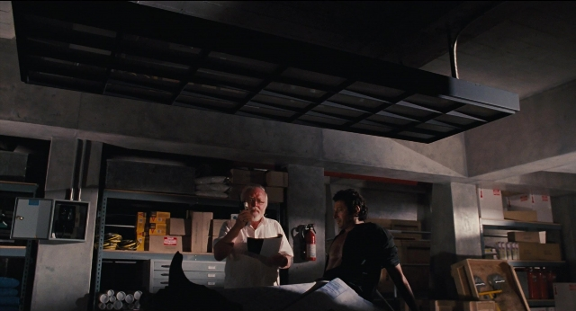 Wide shot frame from Jurassic Park — sitting, room, bed