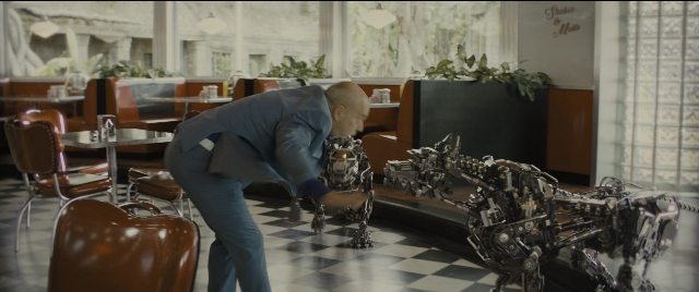 Wide shot frame from Kingsman: The Golden Circle — table, suit, restaurant