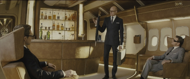 Wide shot frame from Kingsman: The Golden Circle — sitting, standing, suit