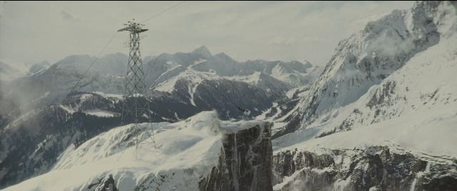 Wide shot frame from Kingsman: The Golden Circle — tower, snow, running