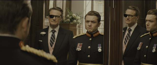 Wide shot frame from Kingsman: The Golden Circle — standing, room, suit