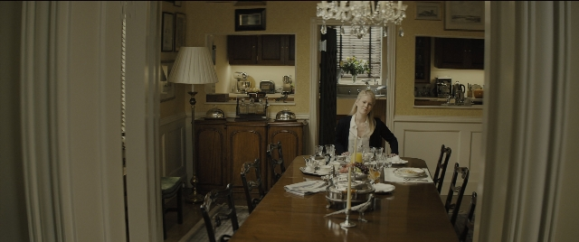 Wide shot frame from Kingsman: The Golden Circle — sitting, room, table