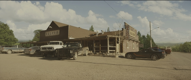 Wide shot frame from Kingsman: The Golden Circle — car, house, restaurant
