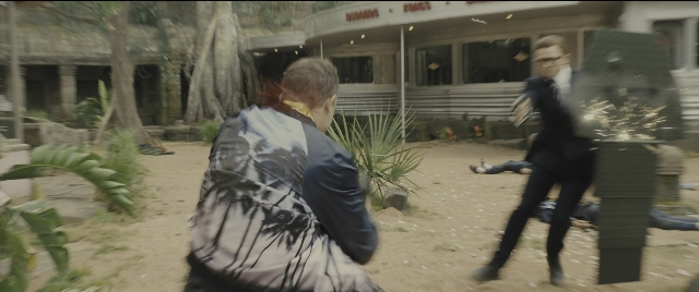 Wide shot frame from Kingsman: The Golden Circle — standing, tie, fight