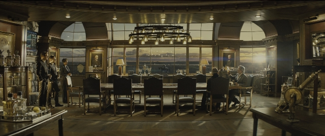 Wide shot frame from Kingsman: The Golden Circle — standing, room, table