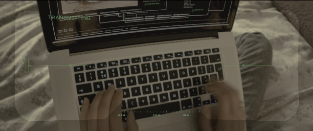 Wide shot frame from Kingsman: The Golden Circle — sitting, bed, laptop