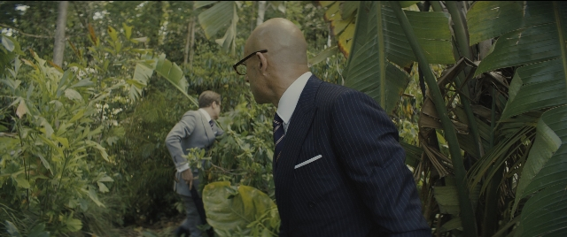 Wide shot frame from Kingsman: The Golden Circle — walking, suit, bag