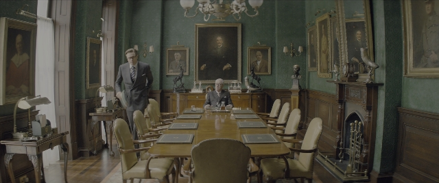 Wide shot frame from Kingsman: The Secret Service — standing, room, table