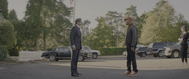Wide shot frame from Kingsman: The Secret Service — standing, dialogue, hat