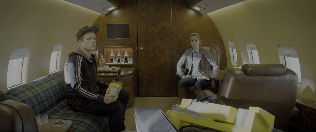 Wide shot frame from Kingsman: The Secret Service — sitting, room, table