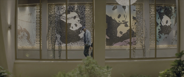 Wide shot frame from Kingsman: The Secret Service — standing, hat, face