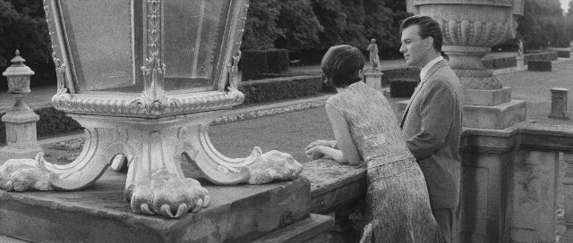 Wide shot frame from L'année dernière à Marienbad — sitting, standing, walking