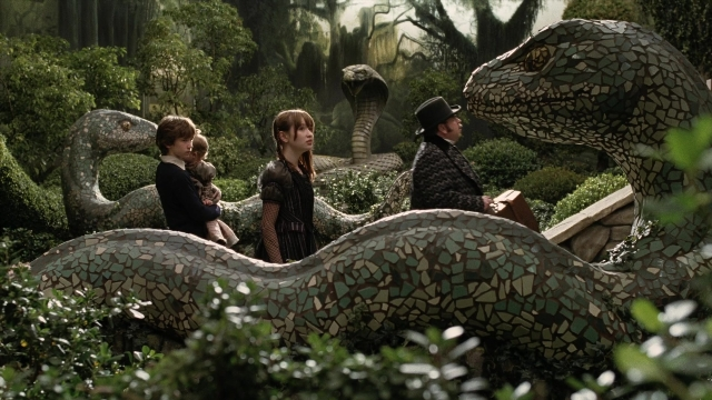 Wide shot frame from A Series of Unfortunate Events — standing, hand, dinosaur
