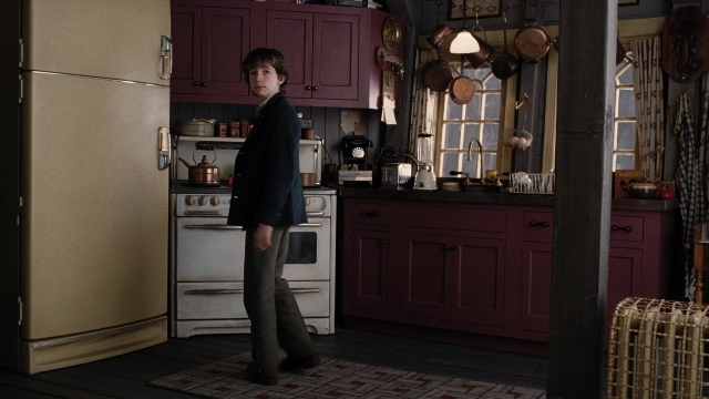 Wide shot frame from A Series of Unfortunate Events — standing, kitchen, refrigerator
