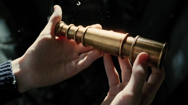 Wide shot frame from A Series of Unfortunate Events — hand, person, binoculars