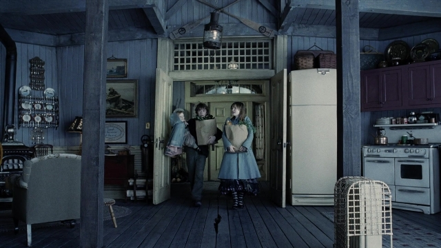 Wide shot frame from A Series of Unfortunate Events — book, standing, table
