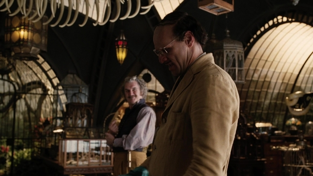Wide shot frame from A Series of Unfortunate Events — standing, room, table