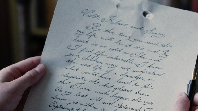 Frame from A Series of Unfortunate Events — hand, penguin, person