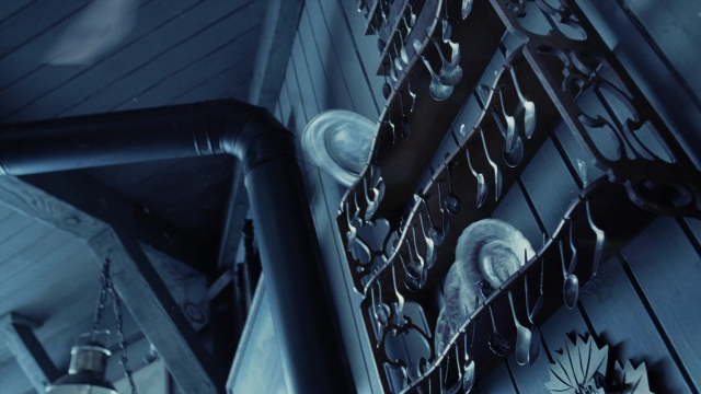 Wide shot frame from A Series of Unfortunate Events — hat, pipe, window