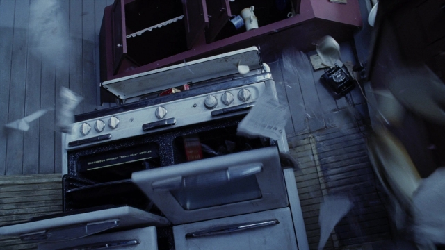Wide shot frame from A Series of Unfortunate Events — door, cabinetry, gas stove