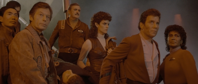 Medium shot frame from Star Trek III: The Search for Spock — standing, bed, shirt