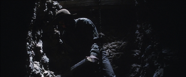 Wide shot frame from There Will Be Blood — hat, person