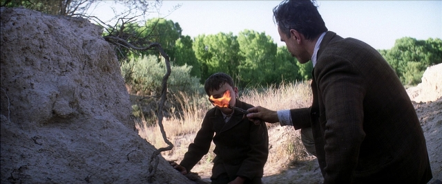 Wide shot frame from There Will Be Blood — standing, hand, suit