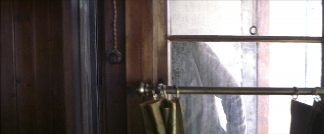 Wide shot frame from There Will Be Blood — window, door handle