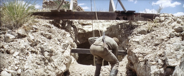 Wide shot frame from There Will Be Blood — hat, person