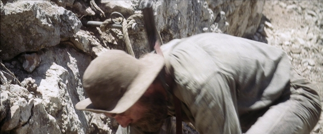 Wide shot frame from There Will Be Blood — hat, shirt, face