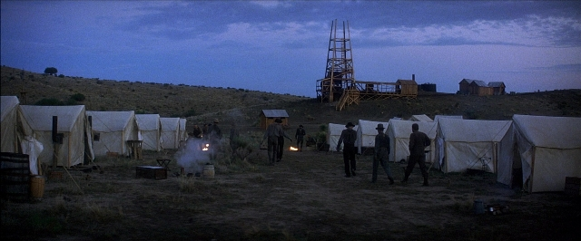 Wide shot frame from There Will Be Blood — standing, tent, person
