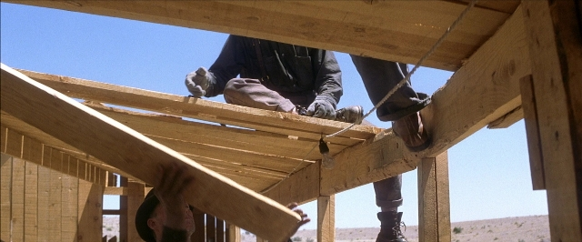 Wide shot frame from There Will Be Blood — standing, person, footwear