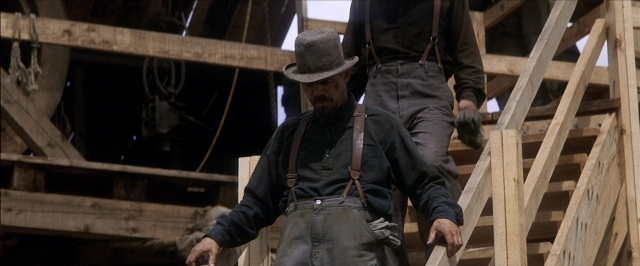 Wide shot frame from There Will Be Blood — standing, walking, room