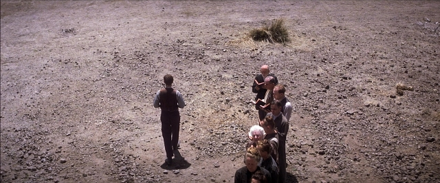 Wide shot frame from There Will Be Blood — standing, person, human face