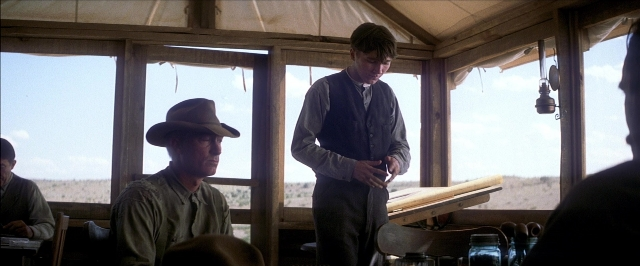 Wide shot frame from There Will Be Blood — sitting, standing, room