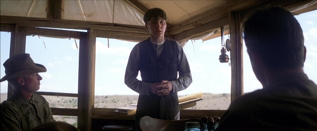 Frame from There Will Be Blood — sitting, standing, table