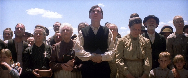 Wide shot frame from There Will Be Blood — book, standing, shirt