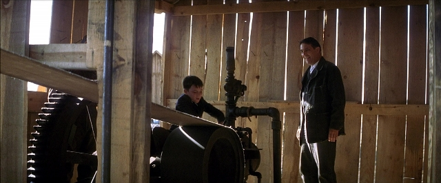 Wide shot frame from There Will Be Blood — standing, room, dialogue