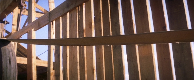 Wide shot frame from There Will Be Blood — hand, person, window