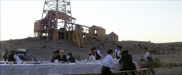 Frame from There Will Be Blood — sitting, standing, table