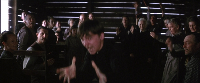Wide shot frame from There Will Be Blood — standing, room, face