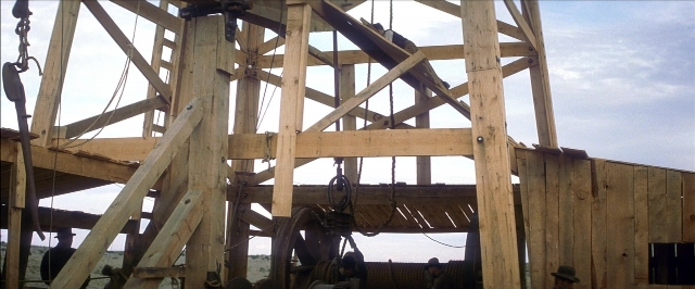 Wide shot frame from There Will Be Blood — water, building