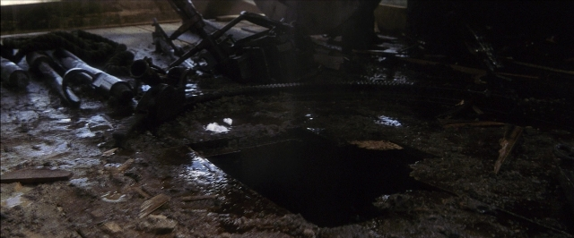 Frame from There Will Be Blood — room, water, car tire