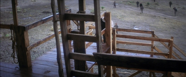 Wide shot frame from There Will Be Blood — walking, furniture, person