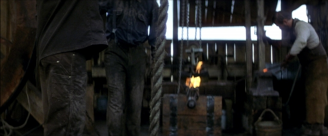 Wide shot frame from There Will Be Blood — standing, person, window