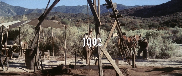 Wide shot frame from There Will Be Blood — standing, horse, person