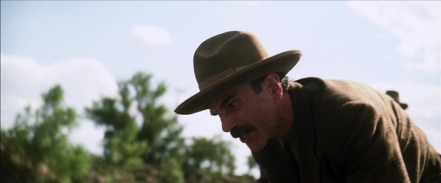 Frame from There Will Be Blood — hat, mustache, face