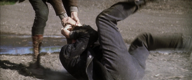 Wide shot frame from There Will Be Blood — water, face, person