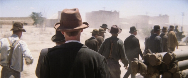 Wide shot frame from There Will Be Blood — walking, hat, person